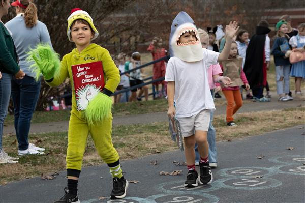 students walking in green and white costume